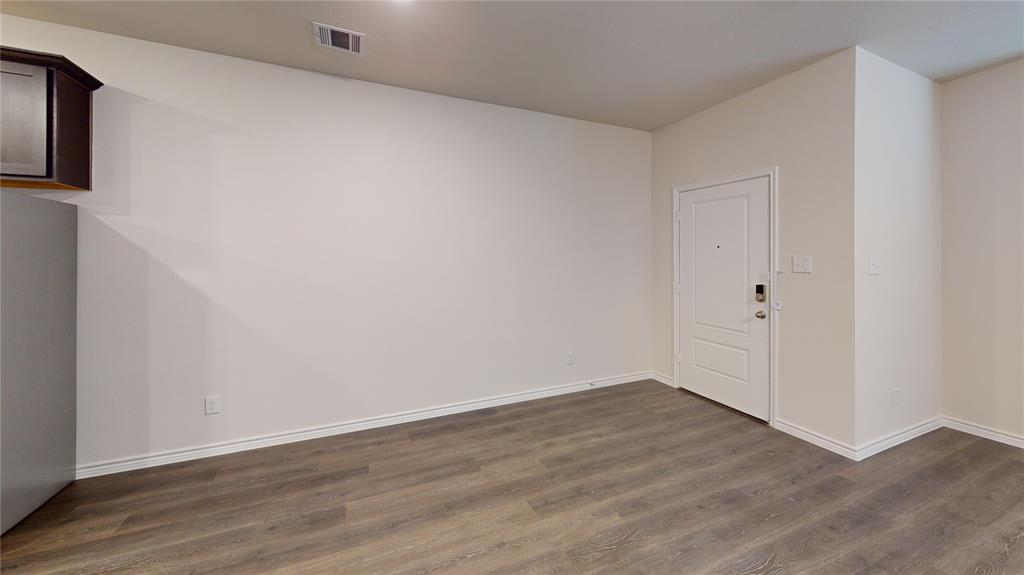 2024 Juniper Pass Way Mesquite, TX 75149 - Photo 16 of 17 a view of an empty room with wooden floor