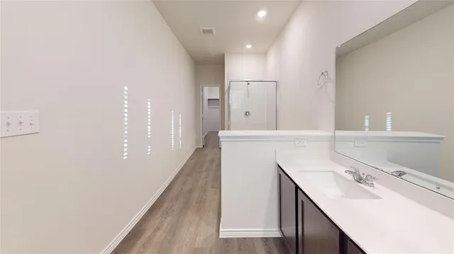 a bathroom with a sink a vanity and a mirror