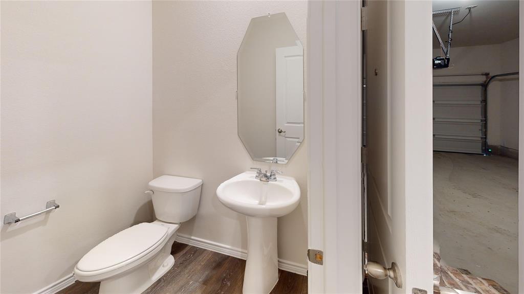 2024 Juniper Pass Way Mesquite, TX 75149 - Photo 3 of 17 a white toilet sitting next to a bathroom sink
