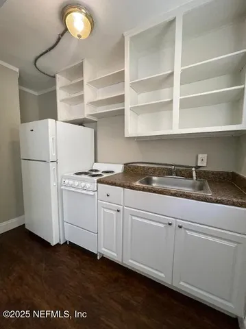 a kitchen with a refrigerator and a stove