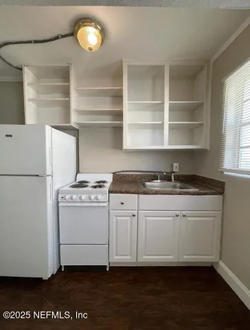 a kitchen with a refrigerator and a stove