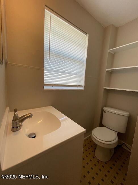 810 2nd Street North, Unit C Jacksonville Beach, FL 32250 - Photo 8 of 17 a bathroom with a sink a toilet and a mirror