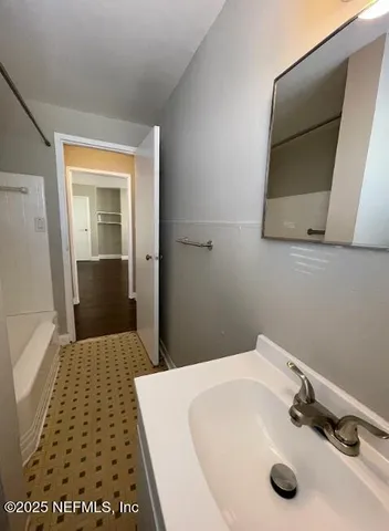 a bathroom with a sink and a mirror