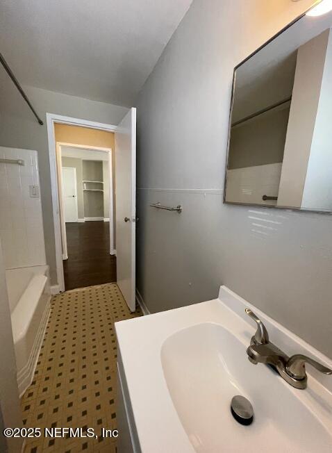 810 2nd Street North, Unit C Jacksonville Beach, FL 32250 - Photo 9 of 17 a bathroom with a sink and a mirror