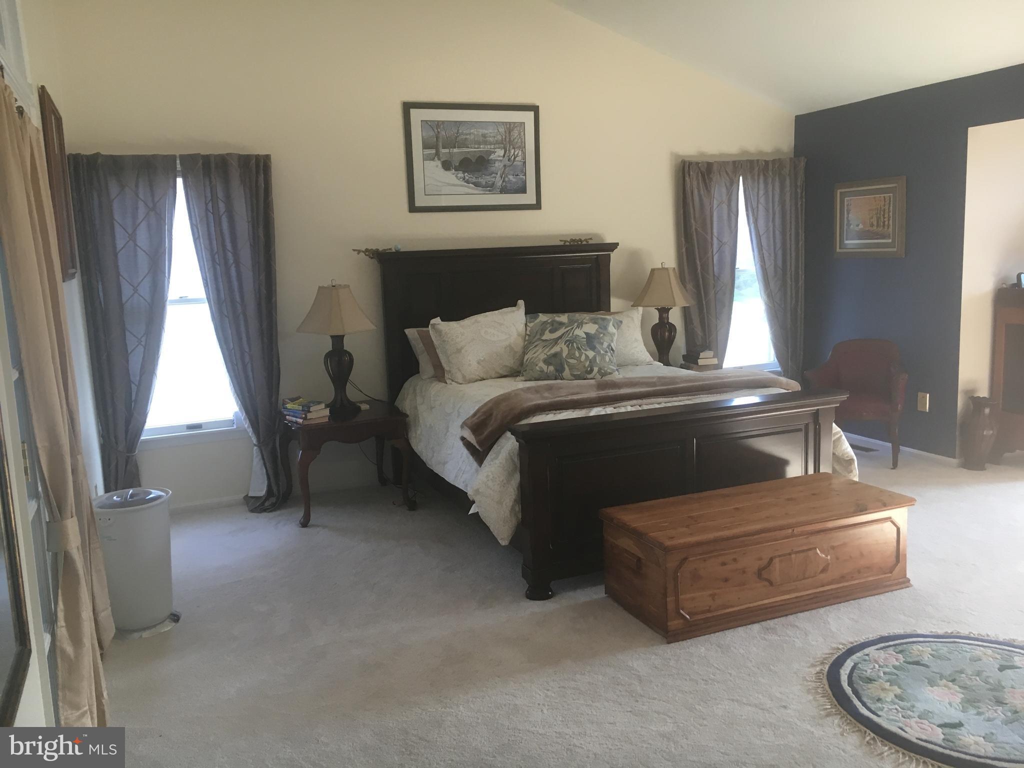 9531 Hallhurst Road Nottingham, MD 21236 - Photo 16 of 30 a bedroom with a bed and a table