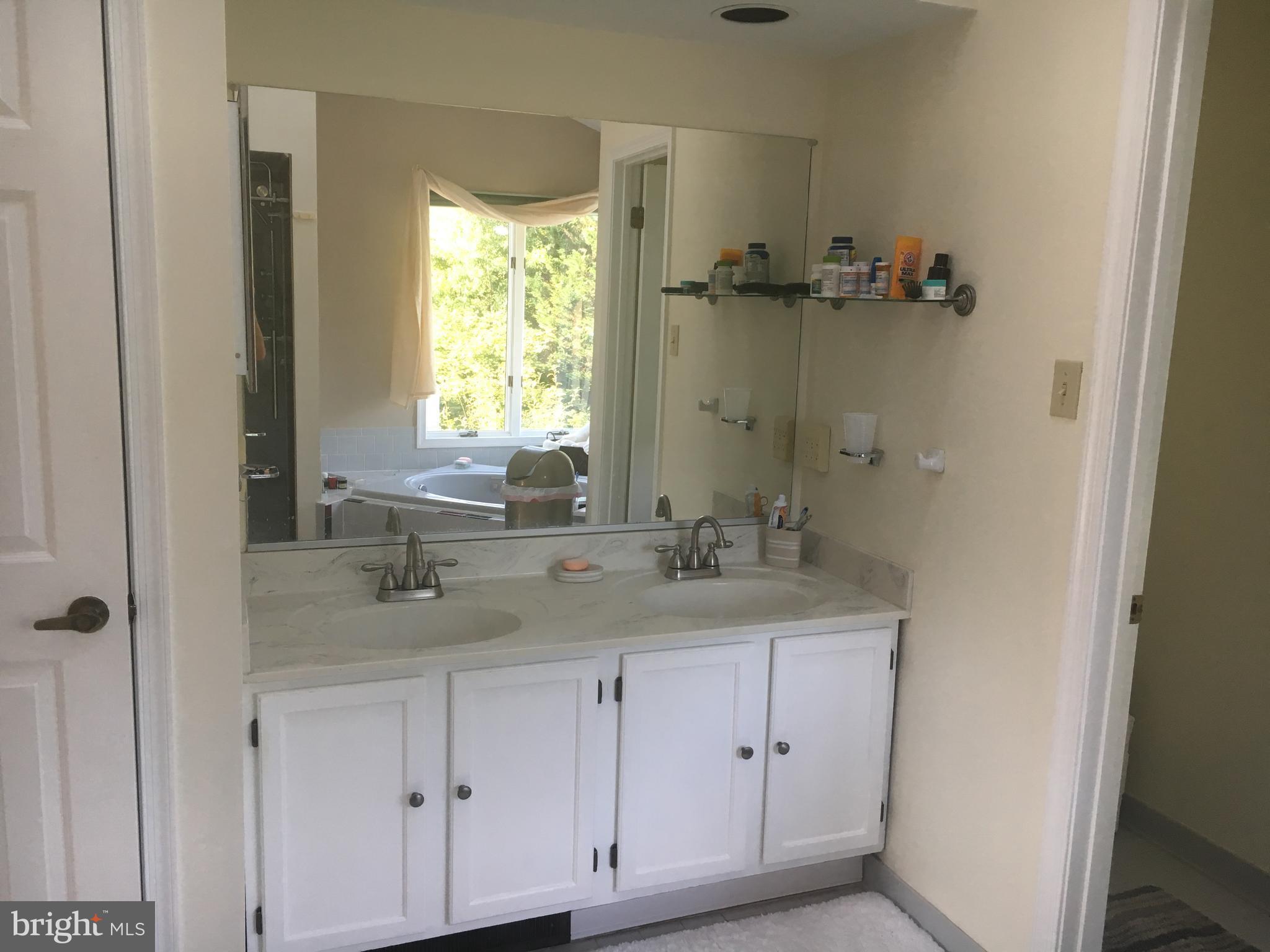 9531 Hallhurst Road Nottingham, MD 21236 - Photo 21 of 30 a bathroom with a granite countertop sink two mirror and window