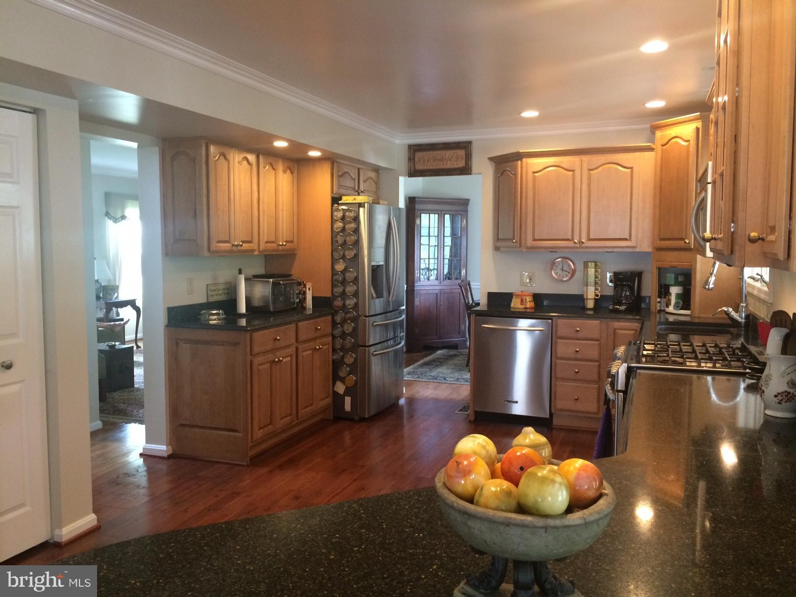 9531 Hallhurst Road Nottingham, MD 21236 - Photo 6 of 30 a kitchen with stainless steel appliances granite countertop a sink a stove and a refrigerator