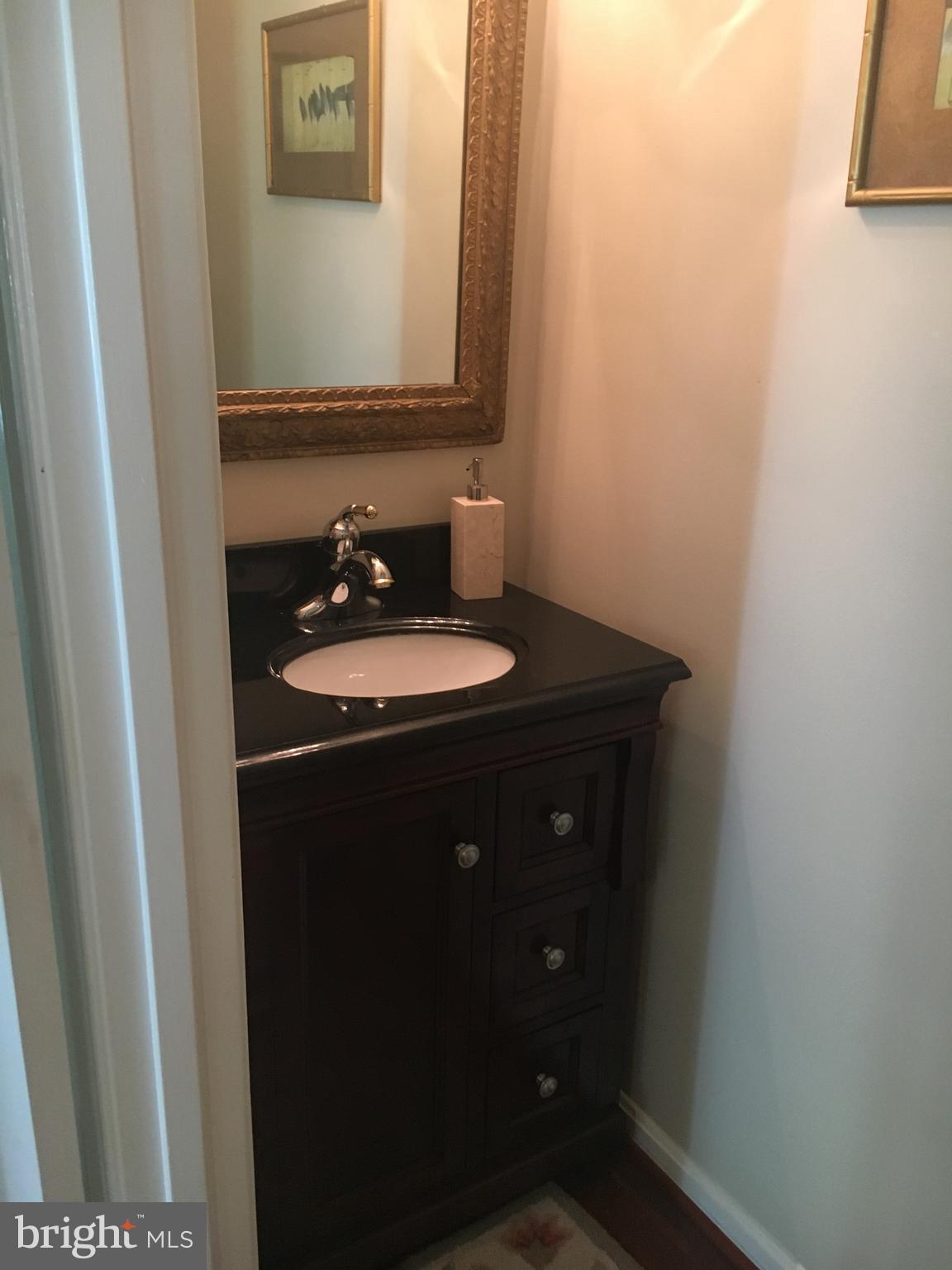 9531 Hallhurst Road Nottingham, MD 21236 - Photo 8 of 30 a bathroom with a sink and a mirror