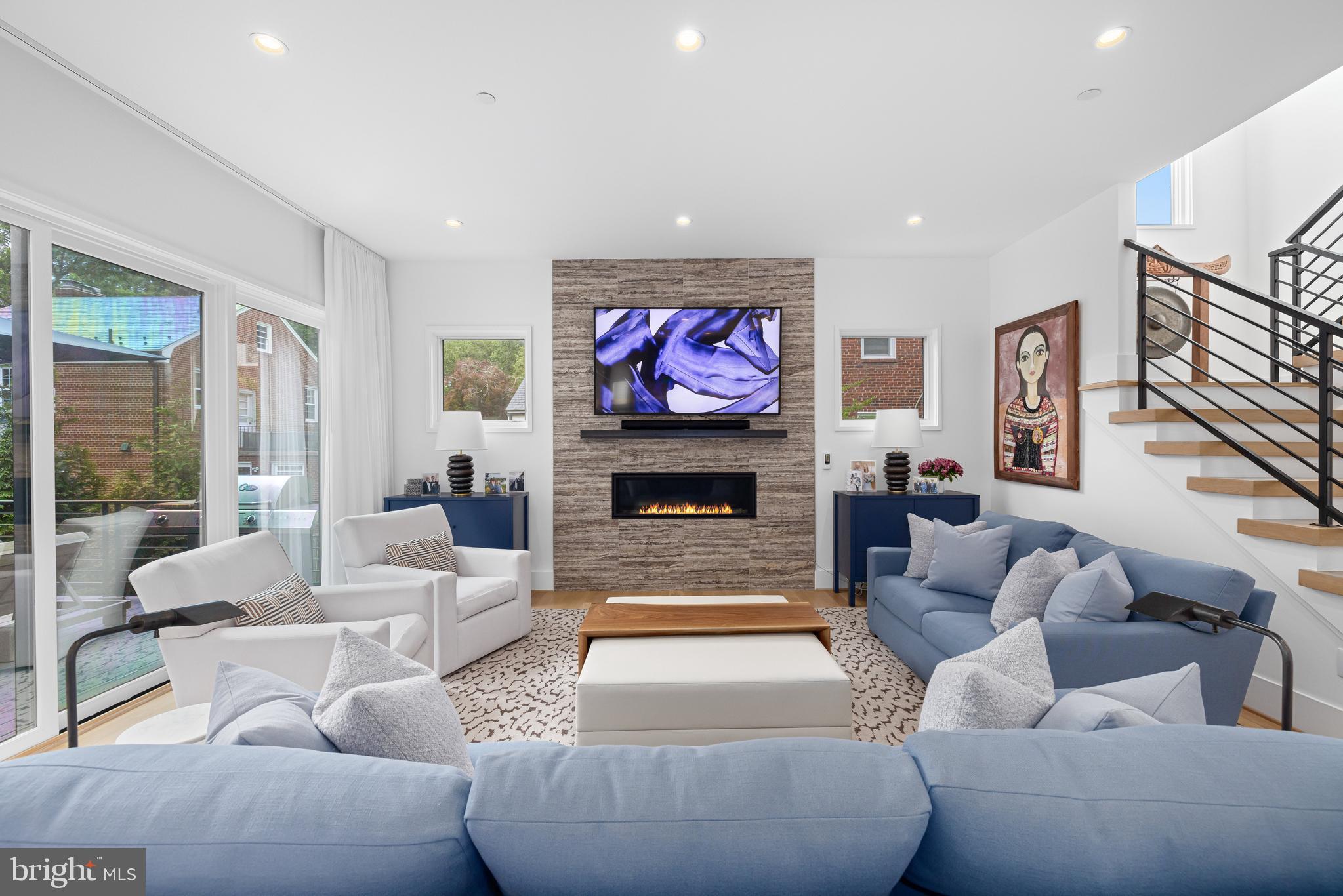 5624 Sherier Place Northwest Washington, DC 20016 - Photo 15 of 60 a living room with furniture a fireplace and a flat screen tv