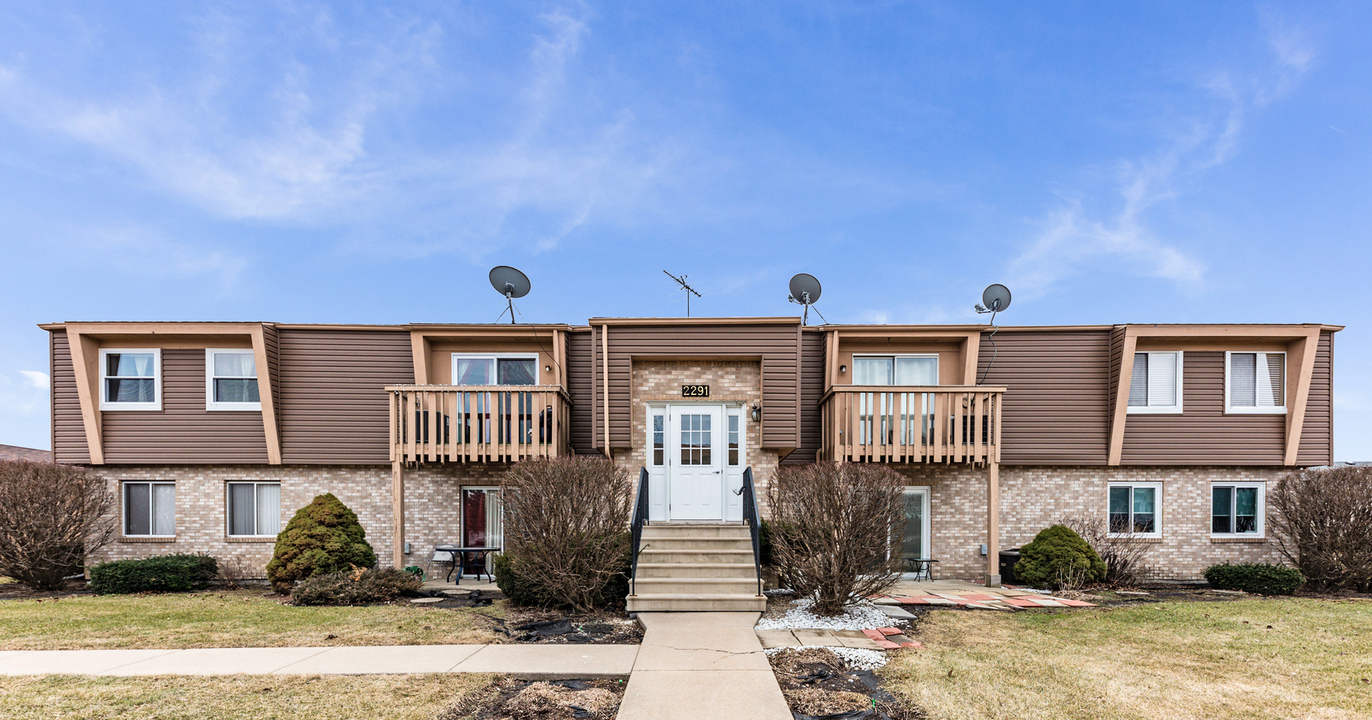 2291 Bicentennial Avenue, Unit 7 Crest Hill, IL 60403 - Photo 1 of 14 a front view of a house with garden