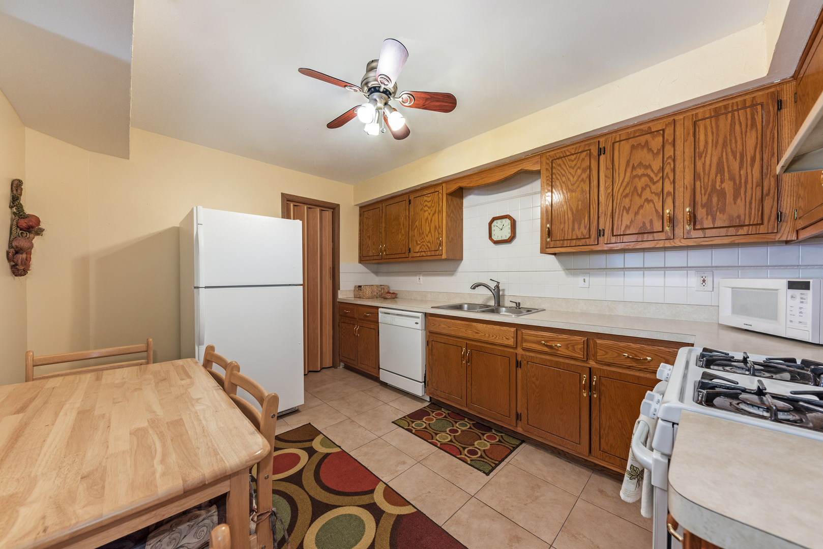 2291 Bicentennial Avenue, Unit 7 Crest Hill, IL 60403 - Photo 2 of 14 a kitchen with a sink appliances and cabinets