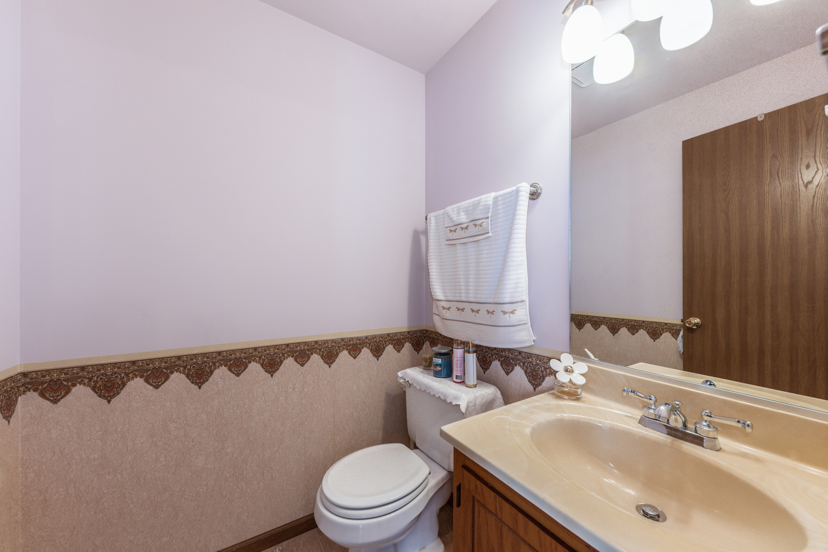 2291 Bicentennial Avenue, Unit 7 Crest Hill, IL 60403 - Photo 8 of 14 a bathroom with a sink vanity mirror and toilet