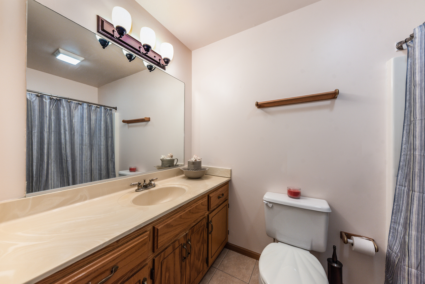2291 Bicentennial Avenue, Unit 7 Crest Hill, IL 60403 - Photo 9 of 14 a bathroom with a sink a toilet and mirror