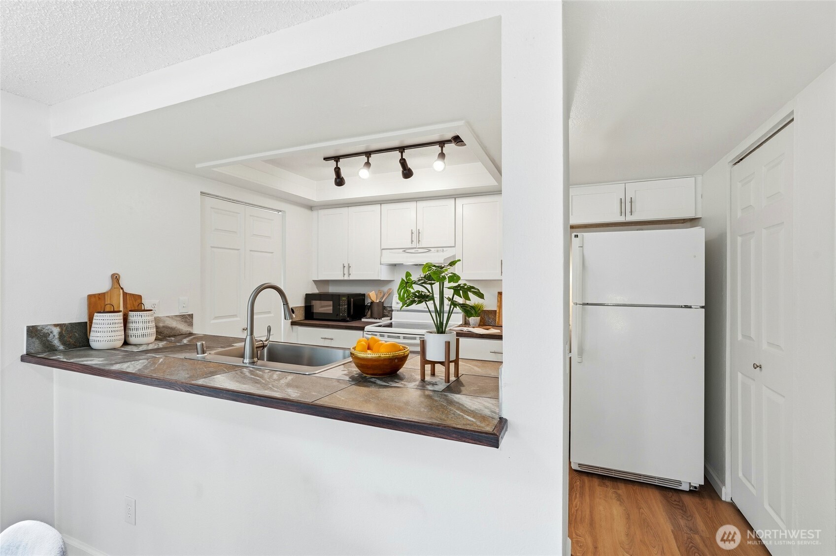 23601 112th Avenue Southeast, Unit A103 Kent, WA 98031 - Photo 12 of 26 a kitchen with a refrigerator and a sink