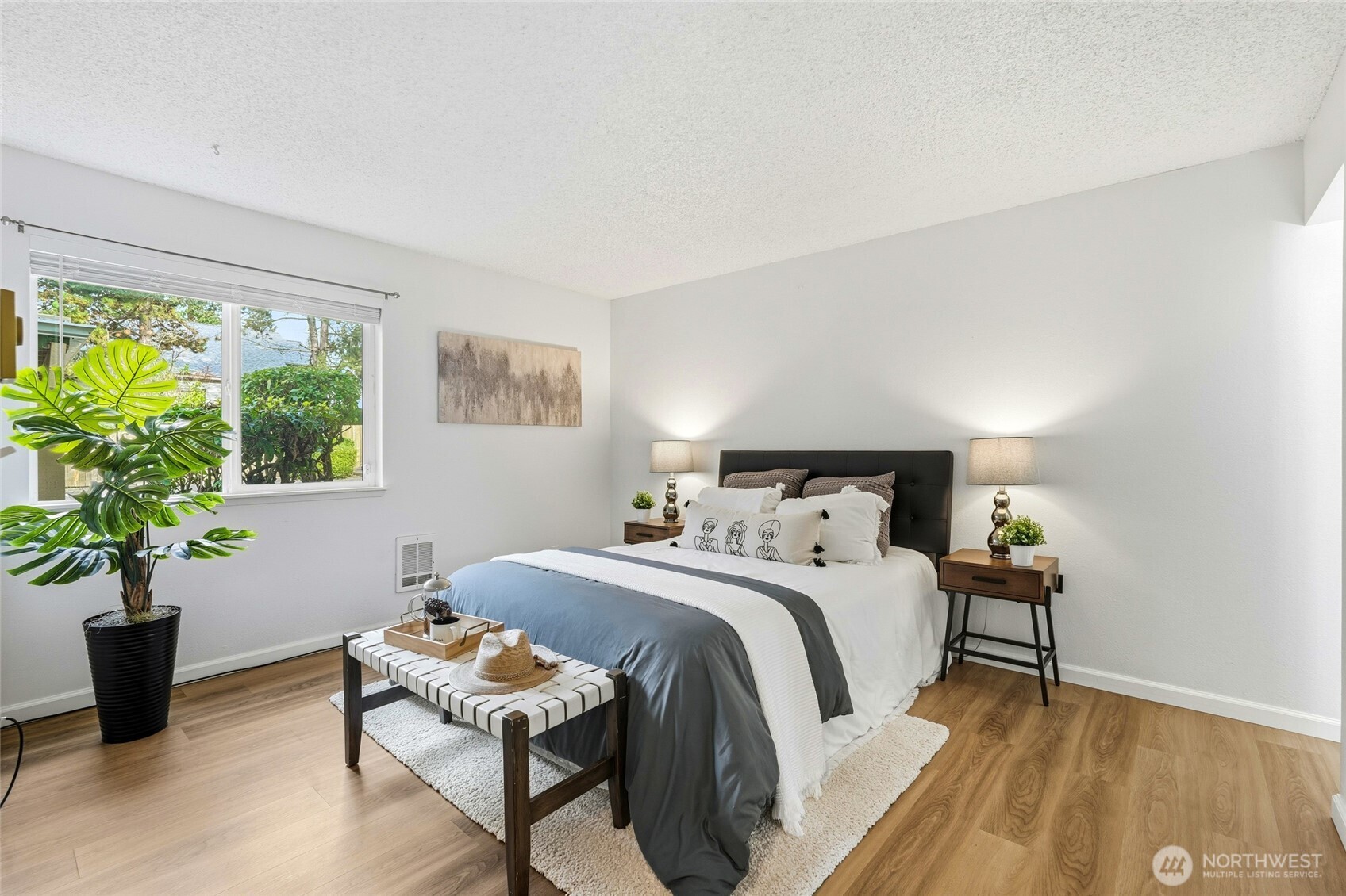 23601 112th Avenue Southeast, Unit A103 Kent, WA 98031 - Photo 17 of 26 a bedroom with a bed and a plant