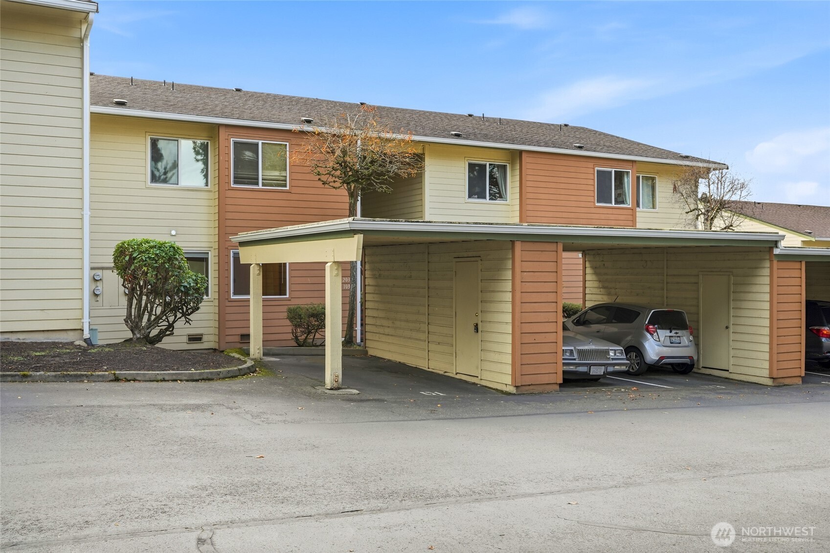 23601 112th Avenue Southeast, Unit A103 Kent, WA 98031 - Photo 2 of 26 a view of a house with a barbeque and wooden fence