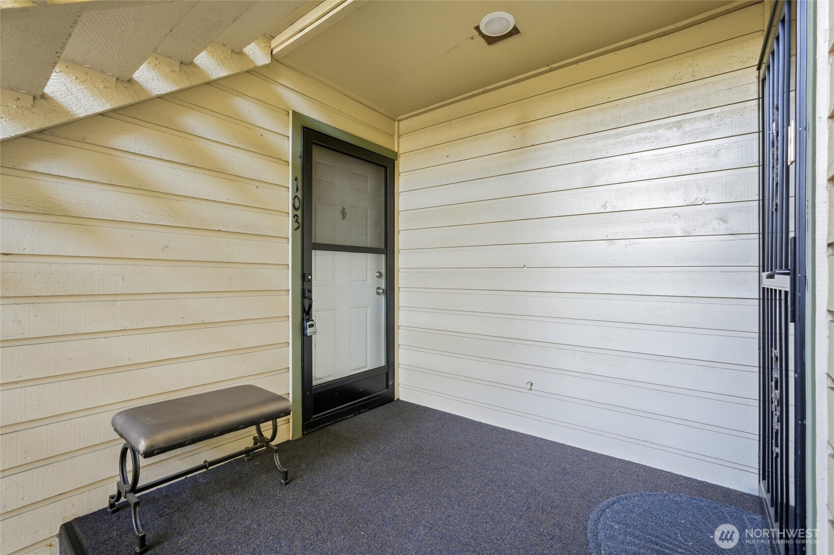 23601 112th Avenue Southeast, Unit A103 Kent, WA 98031 - Photo 4 of 26 a view of a door and chair in the balcony