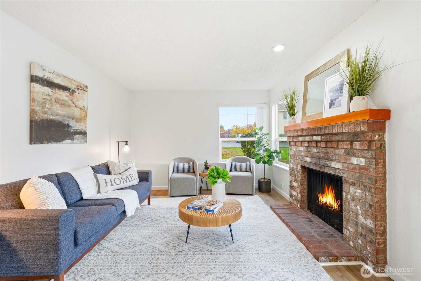 23601 112th Avenue Southeast, Unit A103 Kent, WA 98031 - Photo 7 of 26 a living room with furniture a fireplace and a potted plant
