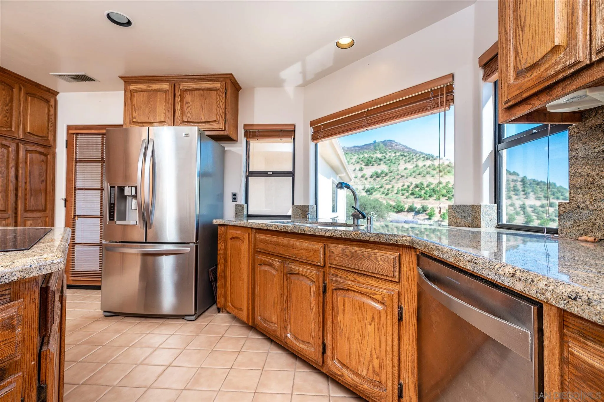 9340 Huntley Road Fallbrook, CA 92028 - Photo 13 of 49 a kitchen with stainless steel appliances granite countertop a refrigerator and a sink