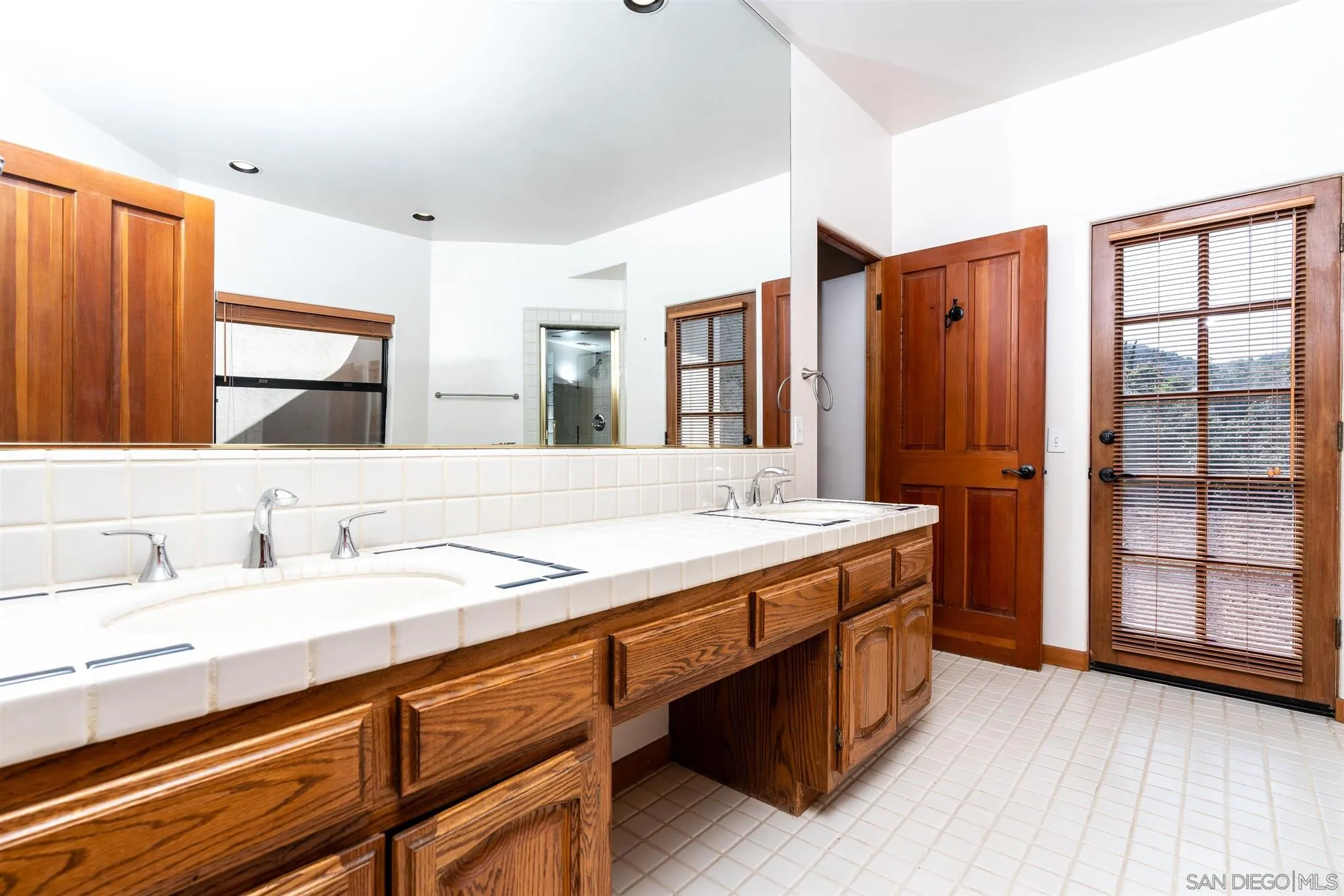 9340 Huntley Road Fallbrook, CA 92028 - Photo 17 of 49 a bathroom with a granite countertop sink and a mirror