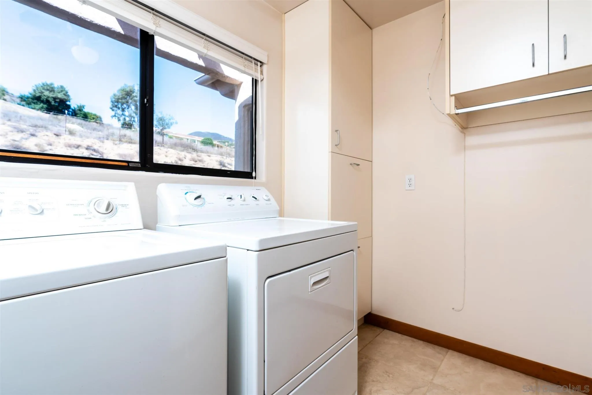 9340 Huntley Road Fallbrook, CA 92028 - Photo 29 of 49 a view of washer and dryer with kitchen view