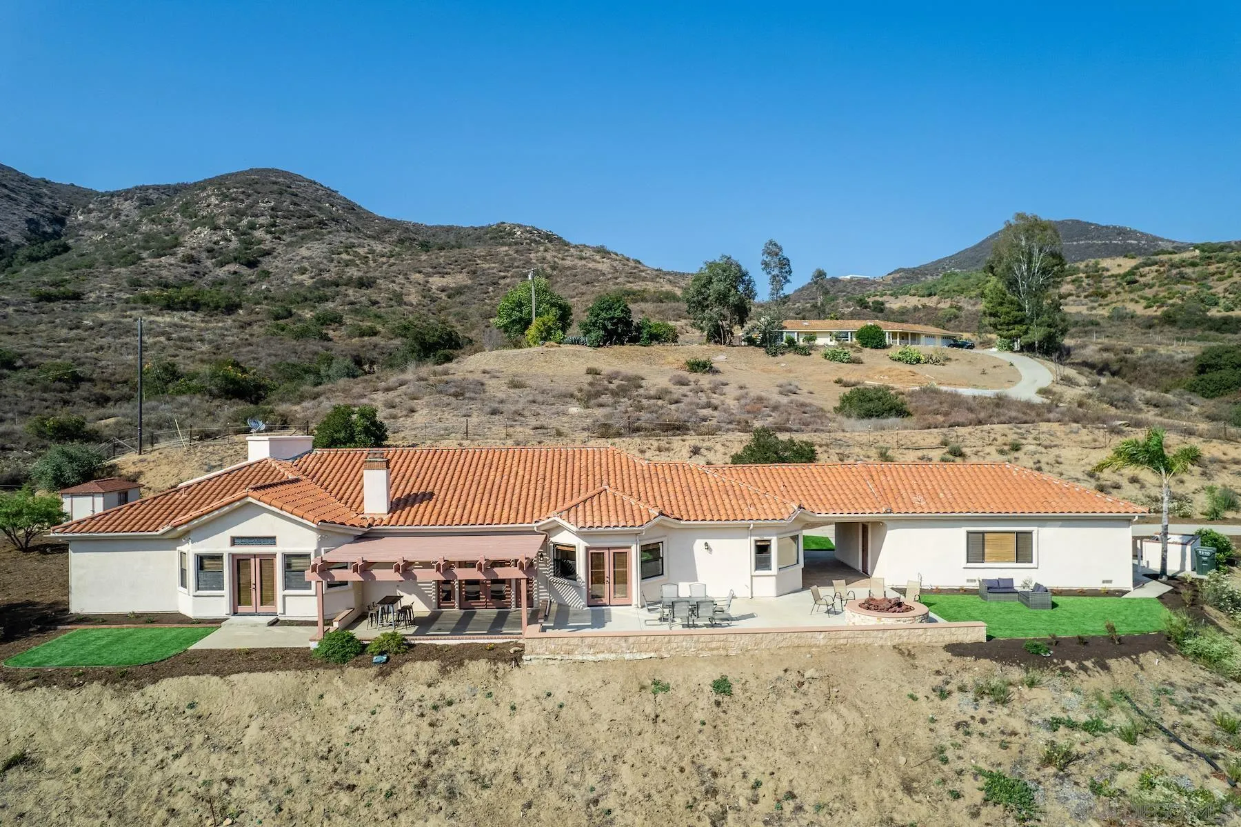 9340 Huntley Road Fallbrook, CA 92028 - Photo 49 of 49 a view of a big house with a big yard and large tree