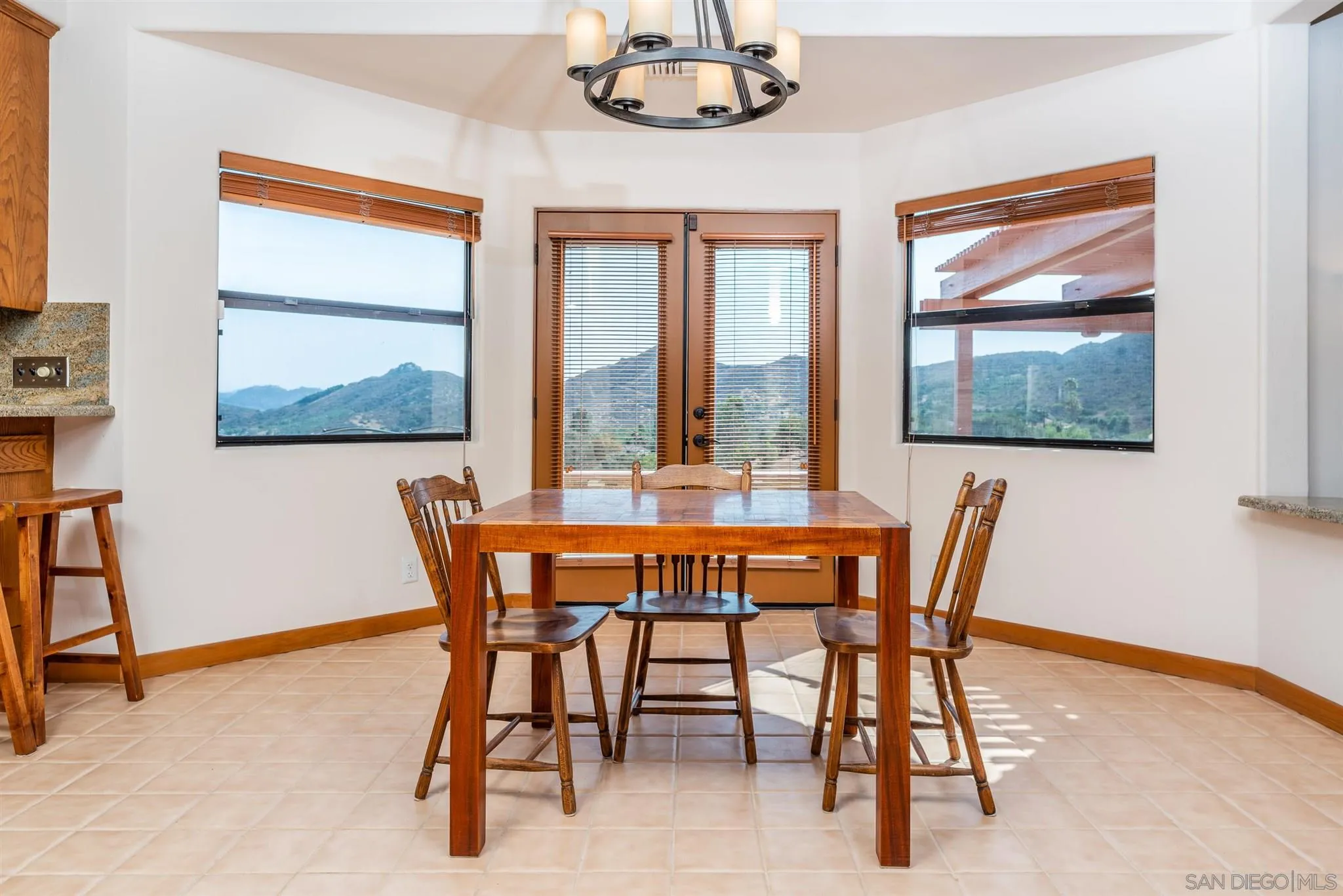9340 Huntley Road Fallbrook, CA 92028 - Photo 10 of 49 a dining room with furniture a rug and a large window