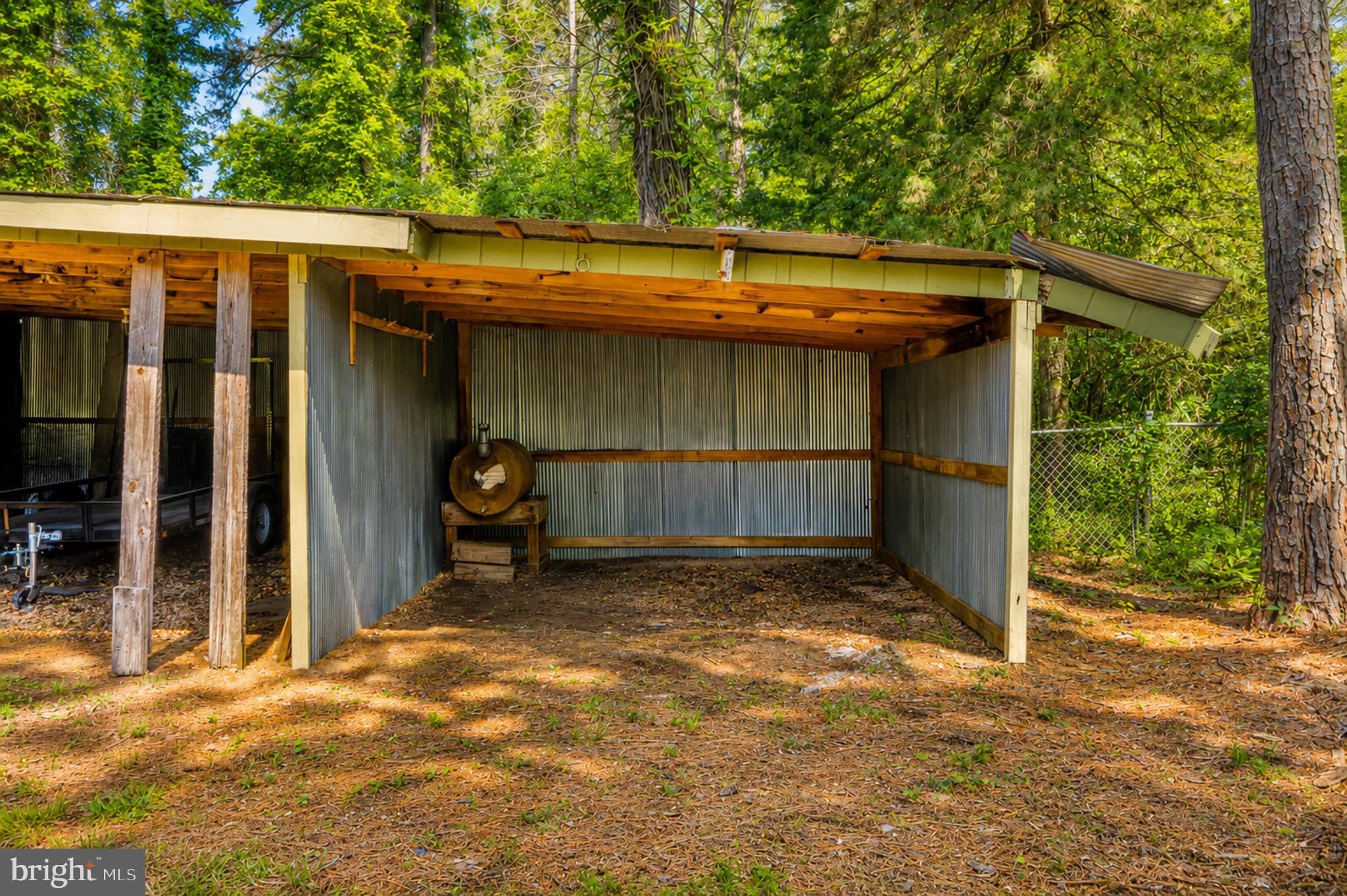 610 Beach Road White Stone, VA 22578 - Photo 21 of 23 Rustic shelter amidst lush greenery.