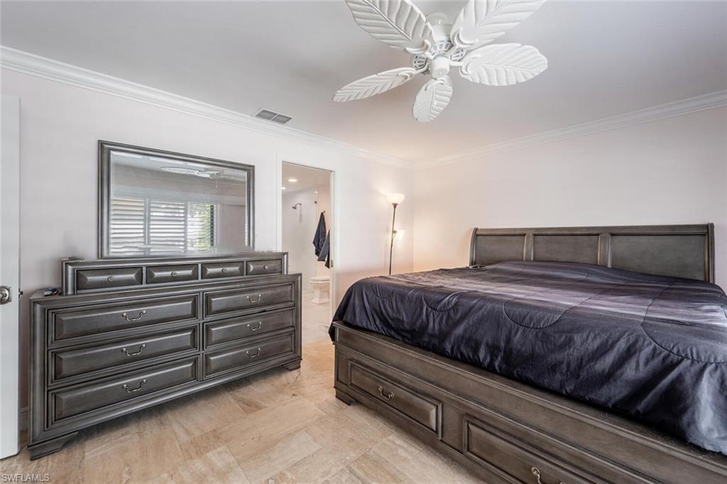 640 Augusta Boulevard Naples, FL 34113 - Photo 11 of 29 a bedroom with a bed and a chandelier