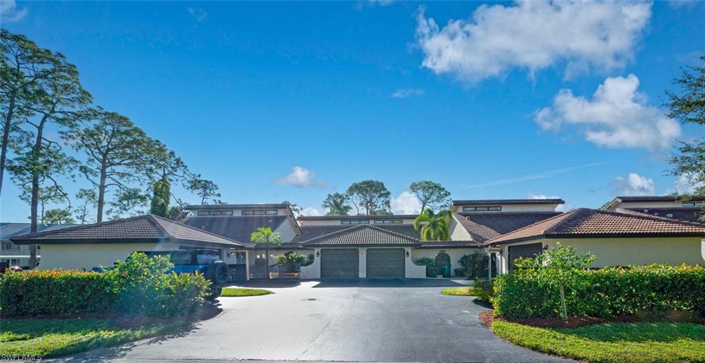 640 Augusta Boulevard Naples, FL 34113 - Photo 17 of 29 a front view of a house with a yard and potted plants