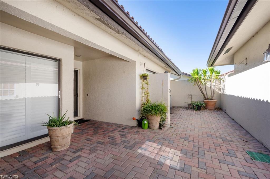 640 Augusta Boulevard Naples, FL 34113 - Photo 21 of 29 a potted plant sitting in front of a glass door