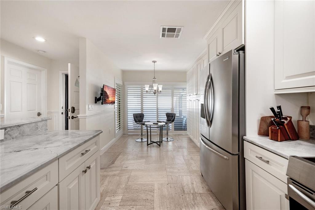 640 Augusta Boulevard Naples, FL 34113 - Photo 3 of 29 a kitchen with granite countertop a refrigerator and a sink