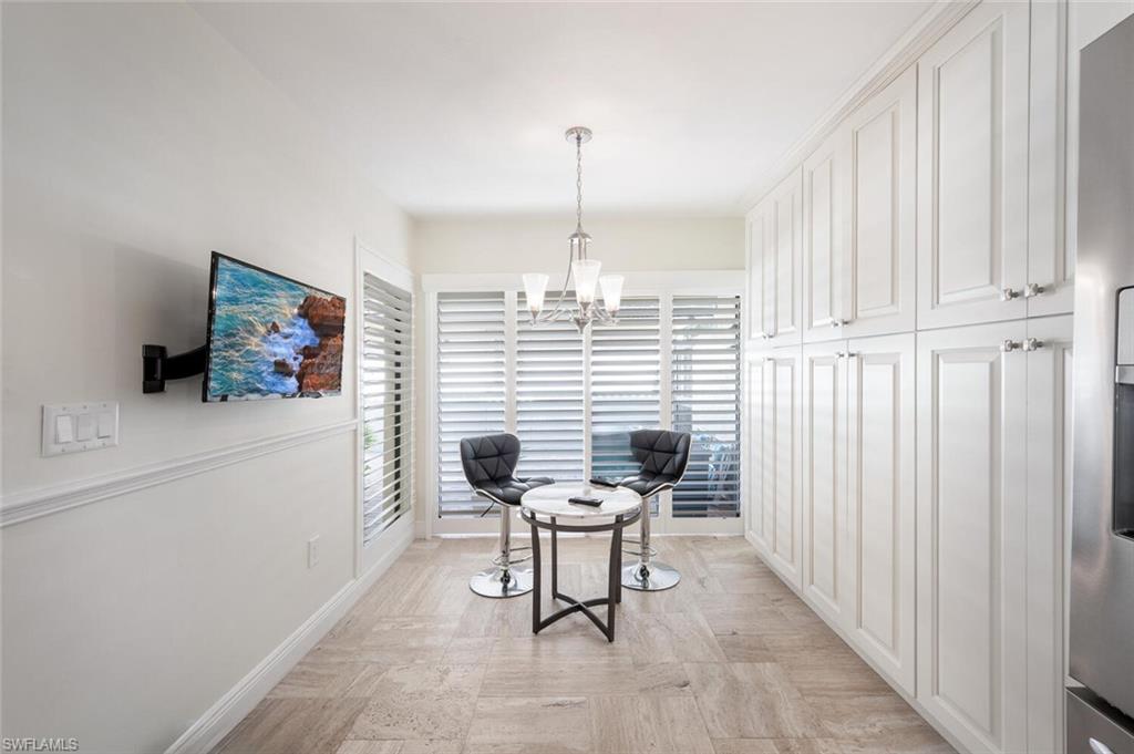 640 Augusta Boulevard Naples, FL 34113 - Photo 4 of 29 a dining room with furniture and a chandelier