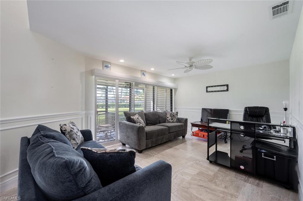640 Augusta Boulevard Naples, FL 34113 - Photo 9 of 29 a living room with furniture and a flat screen tv