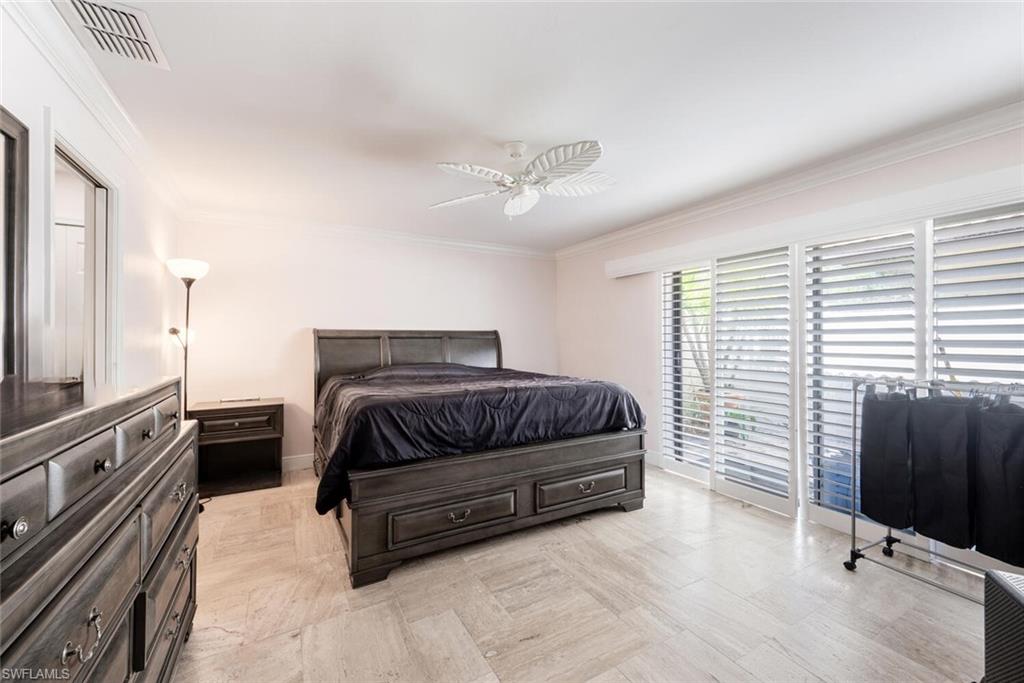 640 Augusta Boulevard Naples, FL 34113 - Photo 10 of 29 a bedroom with a bed and a television
