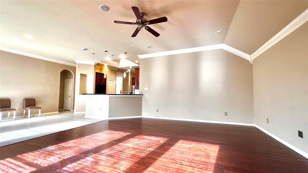 2712 Flint Rock Drive Fort Worth, TX 76131 - Photo 11 of 26 a view of a kitchen with wooden floor and a ceiling fan