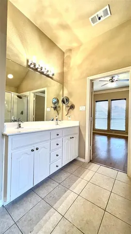 a bathroom with a shower and a mirror