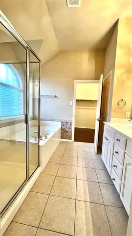 a spacious bathroom with a tub and shower