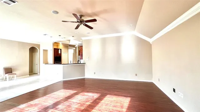 a view of a room with window and ceiling fan