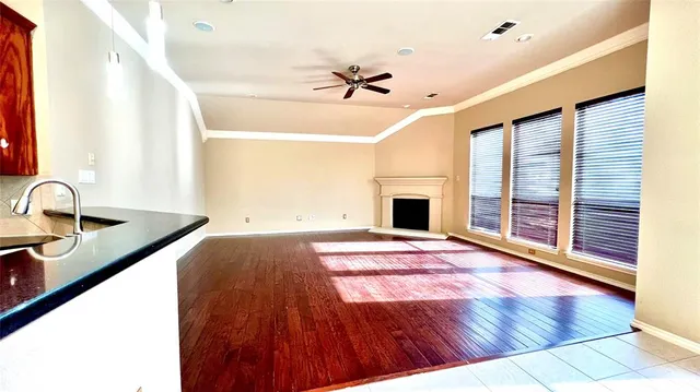 a view of a kitchen with a sink and a fireplace
