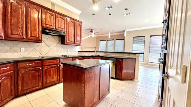 a kitchen with stainless steel appliances granite countertop a sink stove and cabinets