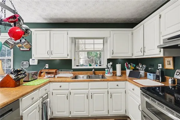 a kitchen with kitchen island granite countertop a sink a cabinets and window