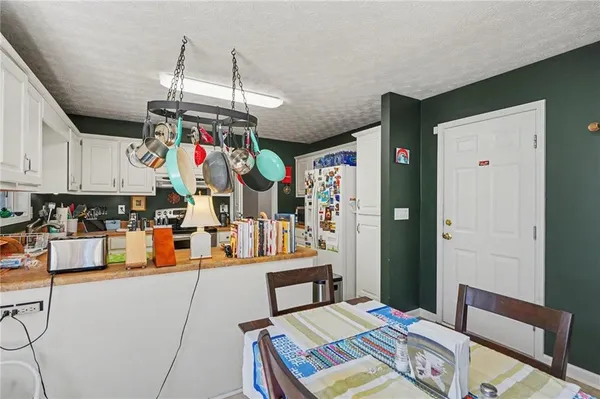 a room with stainless steel appliances lots of wooden furniture