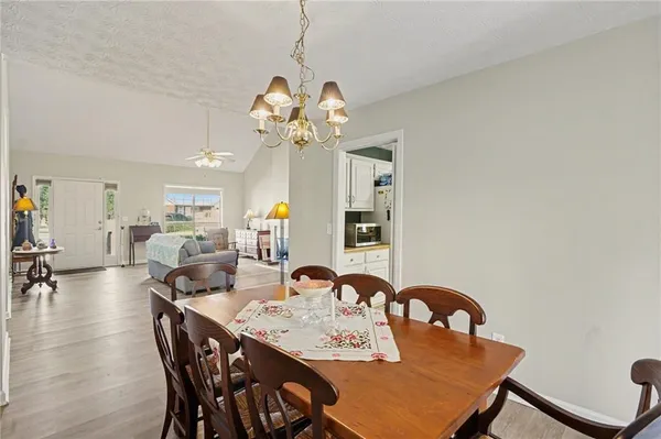 a view of a dining room with furniture and chandelier