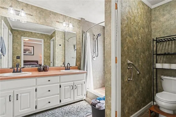 a spacious bathroom with a shower sink and toilet