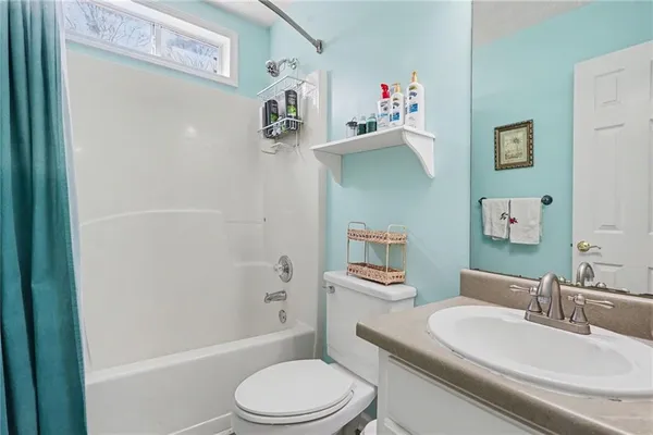 a white toilet sitting next to a bathroom sink