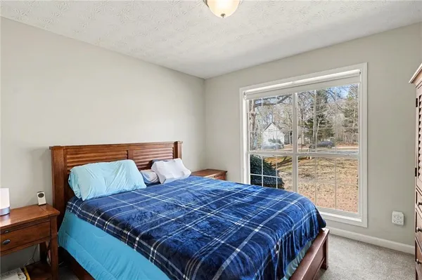 a bed sitting in a bedroom next to a window
