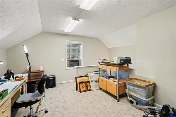 a room with furniture a air conditioner and a window