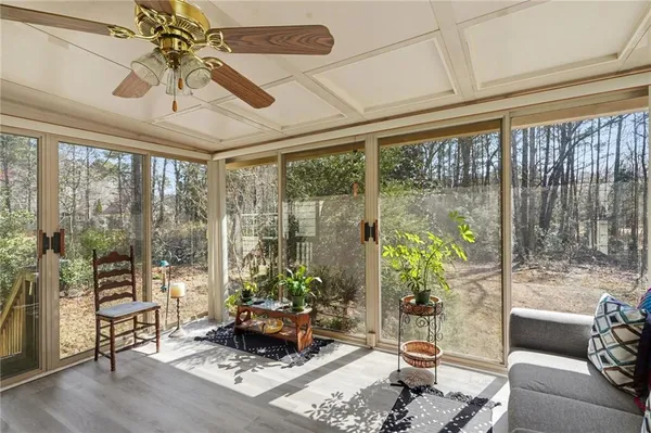 a living room with furniture and a floor to ceiling window