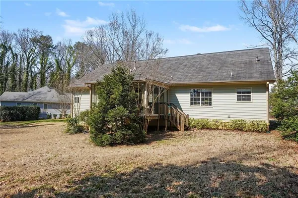 a view of a house with a yard and potted plants